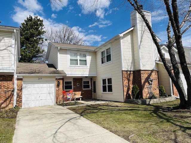 traditional-style home featuring concrete driveway, an attached garage, brick siding, and a front lawn