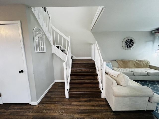 stairway with wood finished floors and baseboards