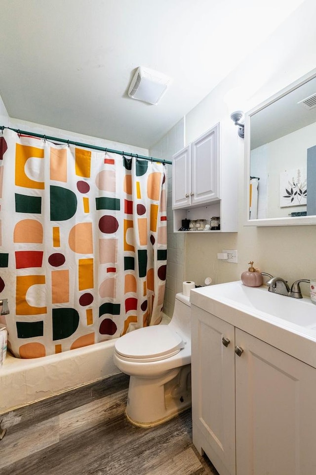 full bathroom with toilet, a shower with curtain, vanity, and wood finished floors