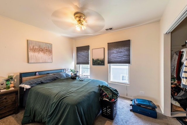 carpeted bedroom featuring ceiling fan, baseboards, and visible vents