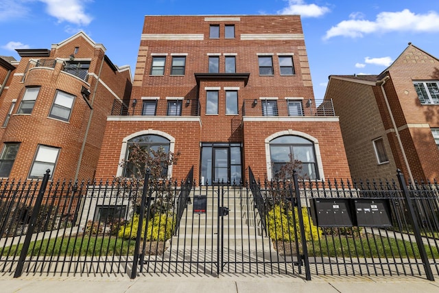 4453 S Lake Park Ave Unit 4, Chicago, IL 60653 - townhome / multi-family property with brick siding and a fenced front yard