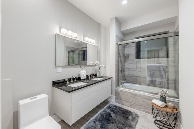 4453 S Lake Park Ave Unit 4, Chicago, IL 60653 - bathroom with a sink, tiled shower / bath, double vanity, and toilet