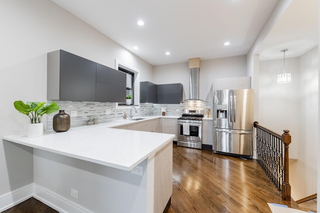 4453 S Lake Park Ave Unit 4, Chicago, IL 60653 - kitchen with a sink, stainless steel appliances, wall chimney exhaust hood, light countertops, and a peninsula