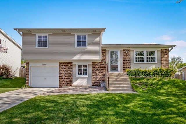 1680 Bicek Dr, Hoffman Estates, IL 60192 - tri-level home with brick siding, a garage, and a front lawn