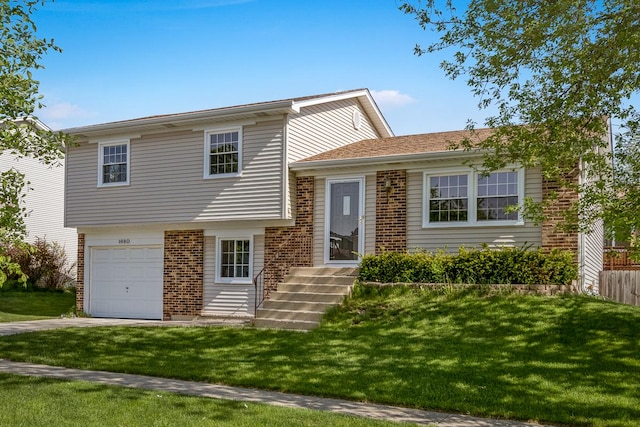 1680 Bicek Dr, Hoffman Estates, IL 60192 - split level home featuring brick siding, an attached garage, a front yard, and concrete driveway