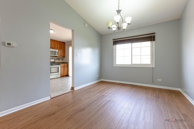 1680 Bicek Dr, Hoffman Estates, IL 60192 - spare room with wood finished floors, a chandelier, and lofted ceiling