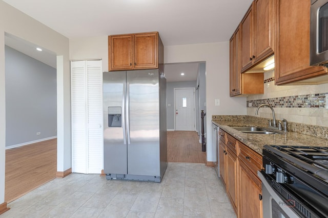 1680 Bicek Dr, Hoffman Estates, IL 60192 - kitchen with stainless steel fridge, stone counters, brown cabinetry, tasteful backsplash, and gas range