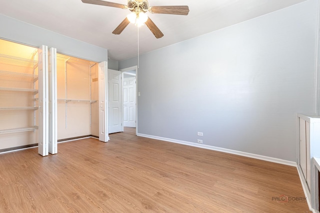 1680 Bicek Dr, Hoffman Estates, IL 60192 - unfurnished bedroom with light wood-style floors, ceiling fan, and multiple closets