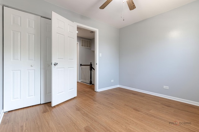 1680 Bicek Dr, Hoffman Estates, IL 60192 - unfurnished bedroom with light wood-style floors, a closet, and a ceiling fan