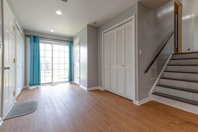 1680 Bicek Dr, Hoffman Estates, IL 60192 - unfurnished living room featuring wood finished floors, recessed lighting, and stairway