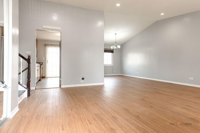 1680 Bicek Dr, Hoffman Estates, IL 60192 - unfurnished living room featuring a chandelier, light wood-type flooring, lofted ceiling, stairs, and recessed lighting