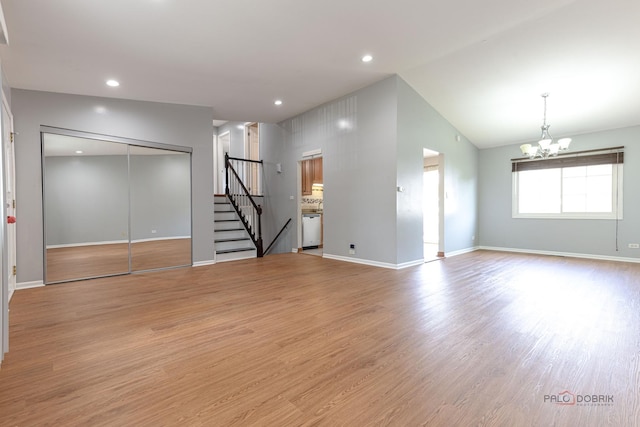 1680 Bicek Dr, Hoffman Estates, IL 60192 - unfurnished living room featuring stairs, a chandelier, wood finished floors, lofted ceiling, and recessed lighting