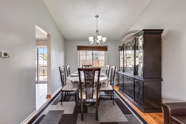 1680 Bicek Dr, Hoffman Estates, IL 60192 - dining space with vaulted ceiling, a chandelier, and wood finished floors
