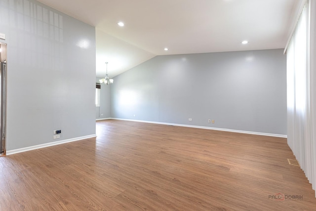 1680 Bicek Dr, Hoffman Estates, IL 60192 - unfurnished room with a chandelier, vaulted ceiling, wood finished floors, and recessed lighting
