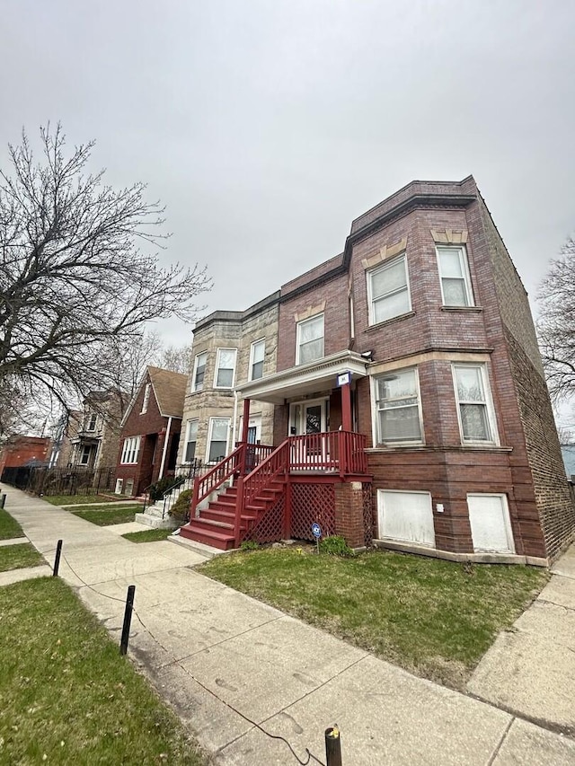 7038 S Vernon Ave, Chicago, IL 60637 - townhome / multi-family property with brick siding, a front yard, and covered porch