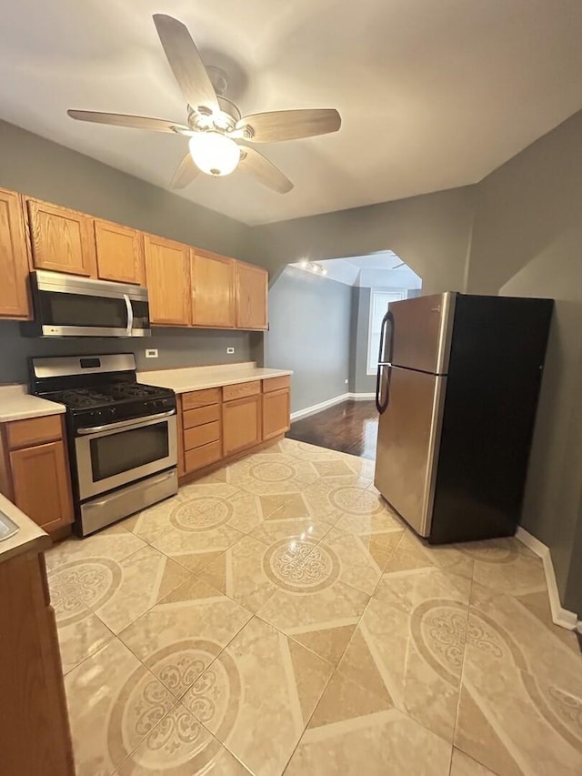 7038 S Vernon Ave, Chicago, IL 60637 - kitchen with appliances with stainless steel finishes, light countertops, a ceiling fan, and baseboards