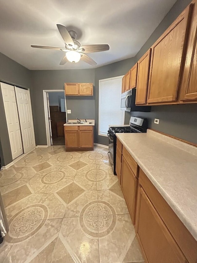7038 S Vernon Ave, Chicago, IL 60637 - kitchen with stainless steel appliances, brown cabinets, and baseboards