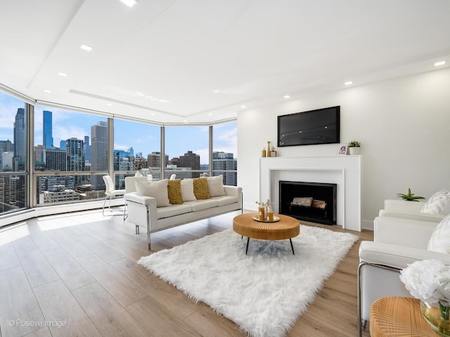 1310 N Ritchie Ct Unit 27B, Chicago, IL 60610 - living area with a skyline view, recessed lighting, wood finished floors, a fireplace with flush hearth, and floor to ceiling windows