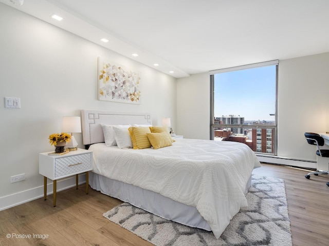 1310 N Ritchie Ct Unit 27B, Chicago, IL 60610 - bedroom with a baseboard heating unit, wood finished floors, recessed lighting, floor to ceiling windows, and baseboards