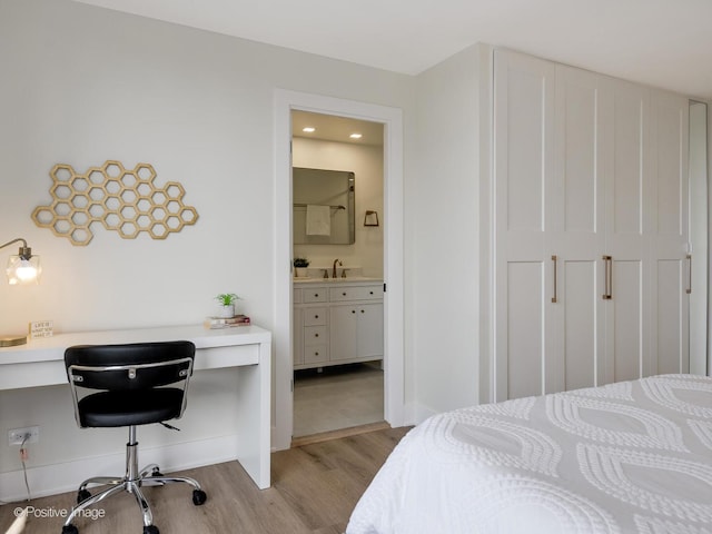 1310 N Ritchie Ct Unit 27B, Chicago, IL 60610 - bedroom with wood finished floors, ensuite bath, baseboards, a sink, and recessed lighting