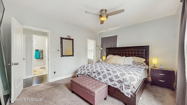bedroom with carpet, baseboards, ensuite bathroom, and a ceiling fan