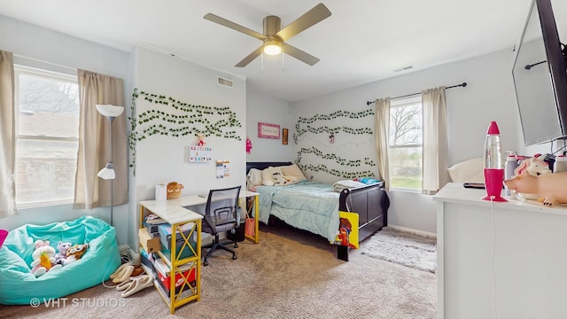 bedroom with light carpet, ceiling fan, and baseboards