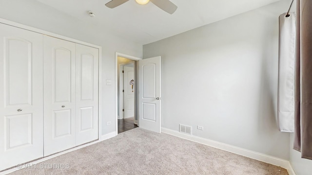 unfurnished bedroom featuring carpet, a closet, and baseboards
