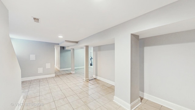 finished basement with recessed lighting, baseboards, and light tile patterned floors