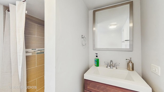 bathroom featuring vanity and a shower with shower curtain