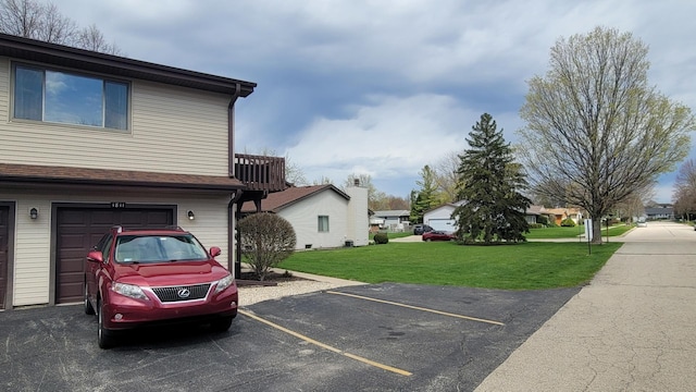exterior space with a yard, a residential view, and uncovered parking