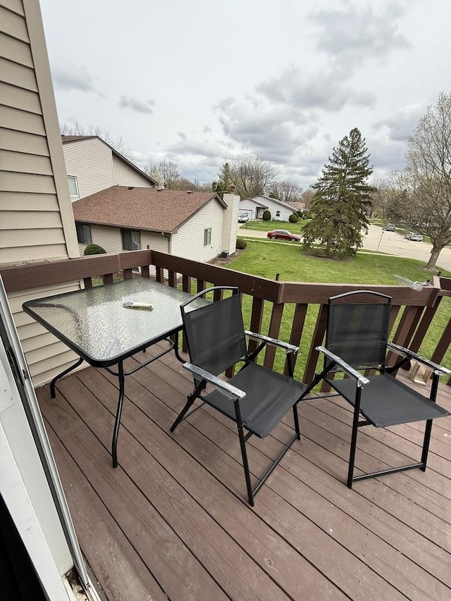 wooden terrace featuring a yard