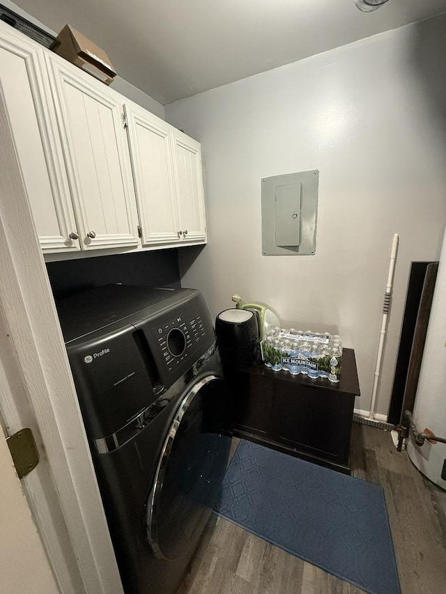clothes washing area featuring washer / dryer, electric panel, dark wood finished floors, and cabinet space