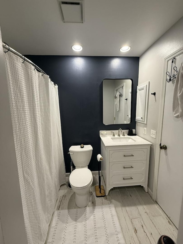 full bath featuring vanity, toilet, recessed lighting, and visible vents