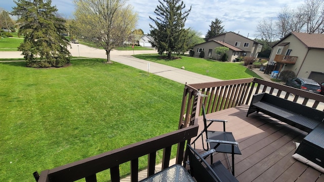 wooden deck with a lawn and a residential view