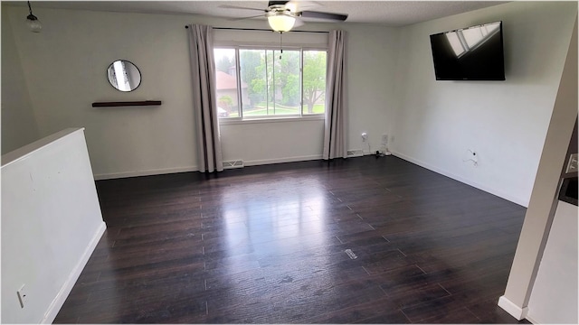 unfurnished living room with baseboards, a ceiling fan, visible vents, and wood finished floors