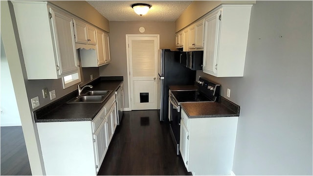 kitchen featuring a sink, dark countertops, dark wood finished floors, stainless steel dishwasher, and electric stove