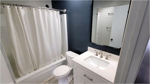 bathroom featuring toilet, shower / tub combo, and vanity