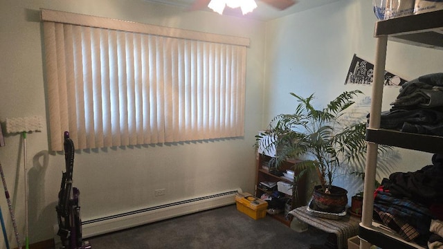 interior space with a baseboard radiator, carpet, and ceiling fan