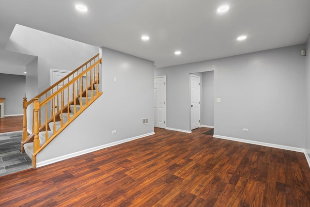 basement featuring baseboards, wood finished floors, recessed lighting, and stairway