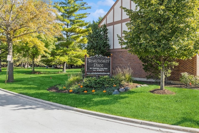 community / neighborhood sign with a lawn