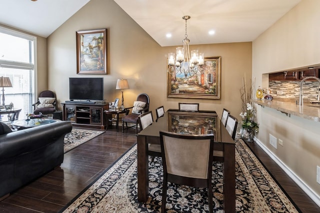 dining room with vaulted ceiling, recessed lighting, a chandelier, and dark wood-style flooring