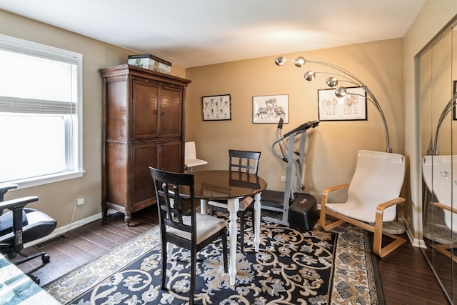 dining room with baseboards and dark wood-style floors