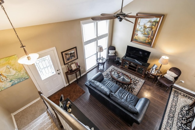 living room with wood finished floors, a ceiling fan, and baseboards