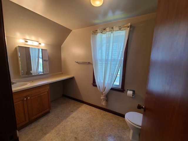 518 3rd Ave, Dixon, IL 61021 - bathroom featuring vaulted ceiling, toilet, vanity, and baseboards