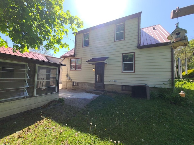 518 3rd Ave, Dixon, IL 61021 - rear view of property featuring metal roof, entry steps, a patio, and a yard