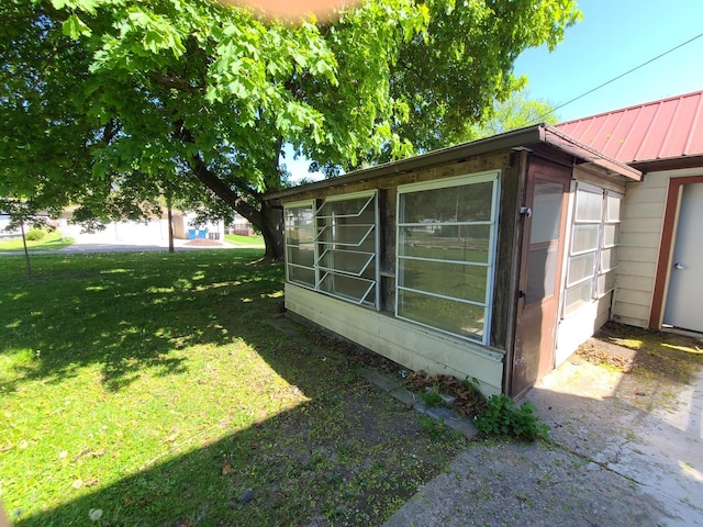 518 3rd Ave, Dixon, IL 61021 - view of home's exterior with metal roof and a yard