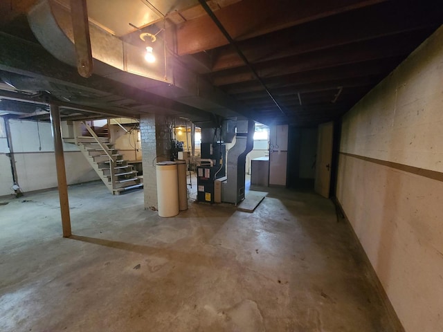 518 3rd Ave, Dixon, IL 61021 - below grade area featuring heating unit, stairway, and a water softener