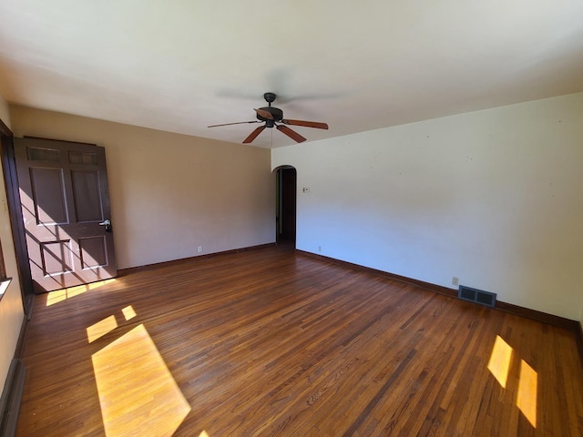 518 3rd Ave, Dixon, IL 61021 - spare room featuring ceiling fan, baseboards, wood finished floors, and arched walkways