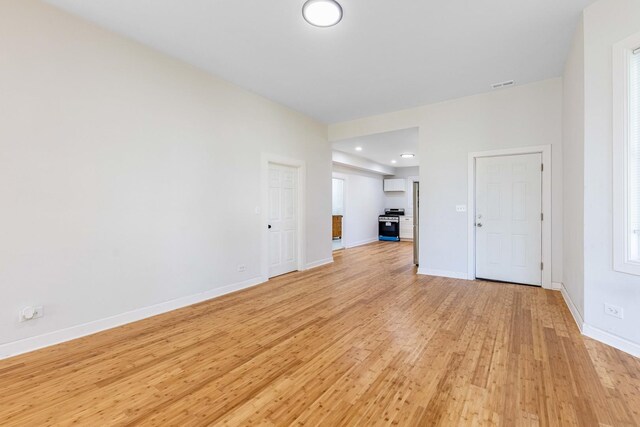unfurnished living room featuring baseboards, visible vents, recessed lighting, and light wood-style floors
