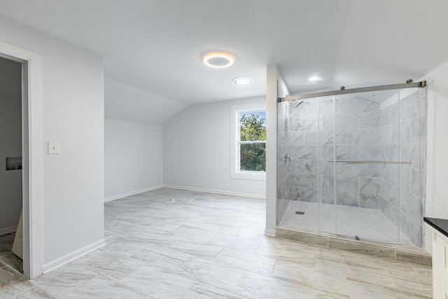 full bathroom with lofted ceiling, baseboards, marble finish floor, and a stall shower